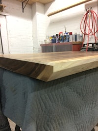 a piece of wood is being sanded in a workshop