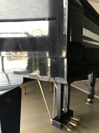 a black piano sitting in a garage