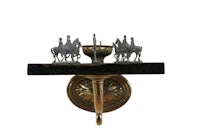 a wall sconce with a statue of horses on it